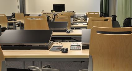 Computers on tables inside an empty room
